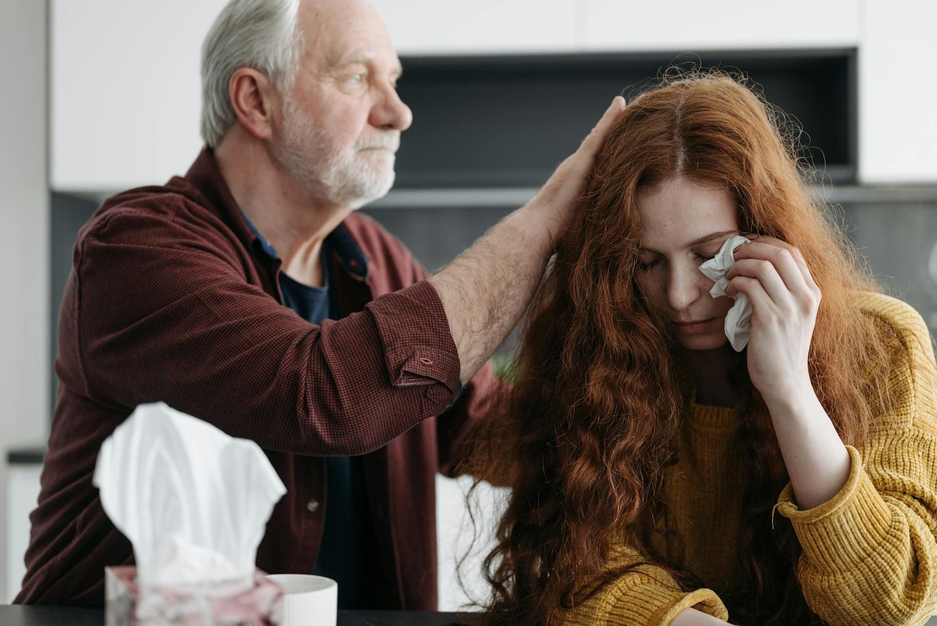 a father consoling his daughter