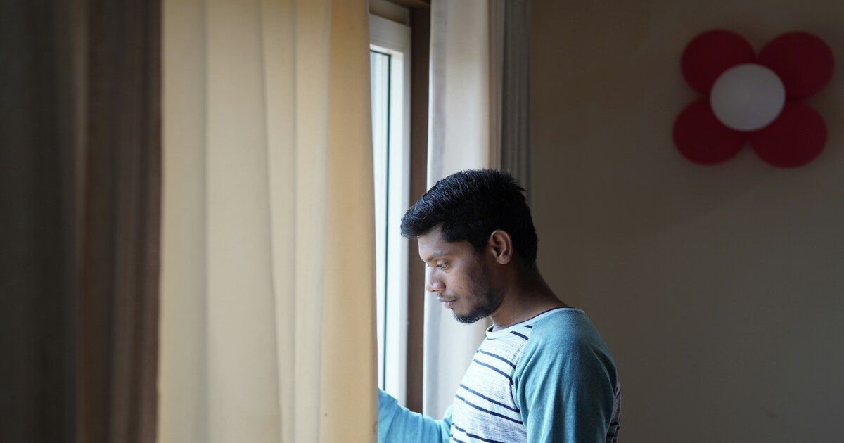 A person standing alone, looking lost and contemplative.