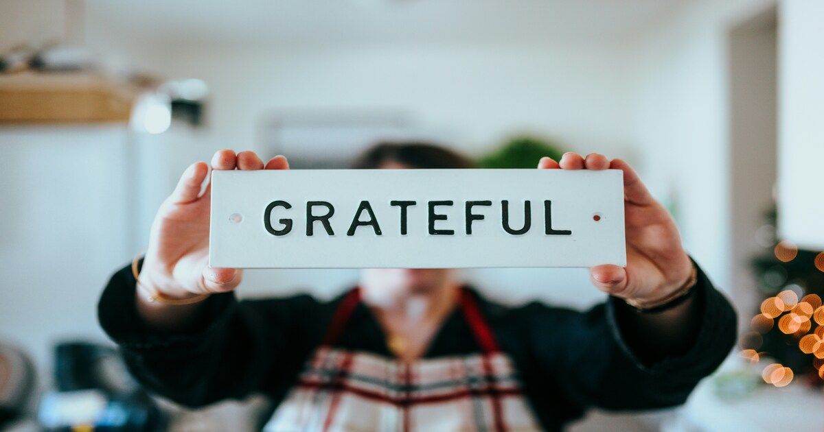 The word “gratitude” written on paper, representing appreciation and self-awareness.