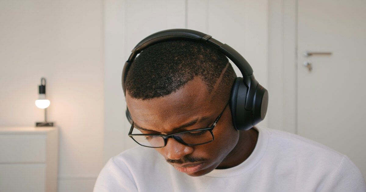 A man wearing headphones, enjoying music and feeling relaxed