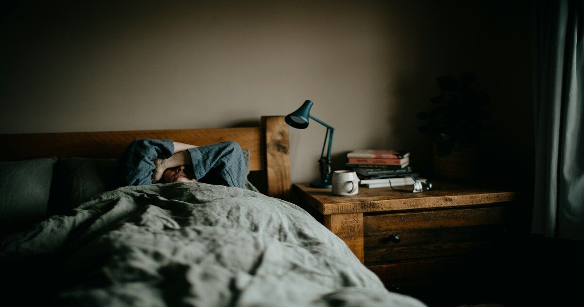 A man waking up in bed
