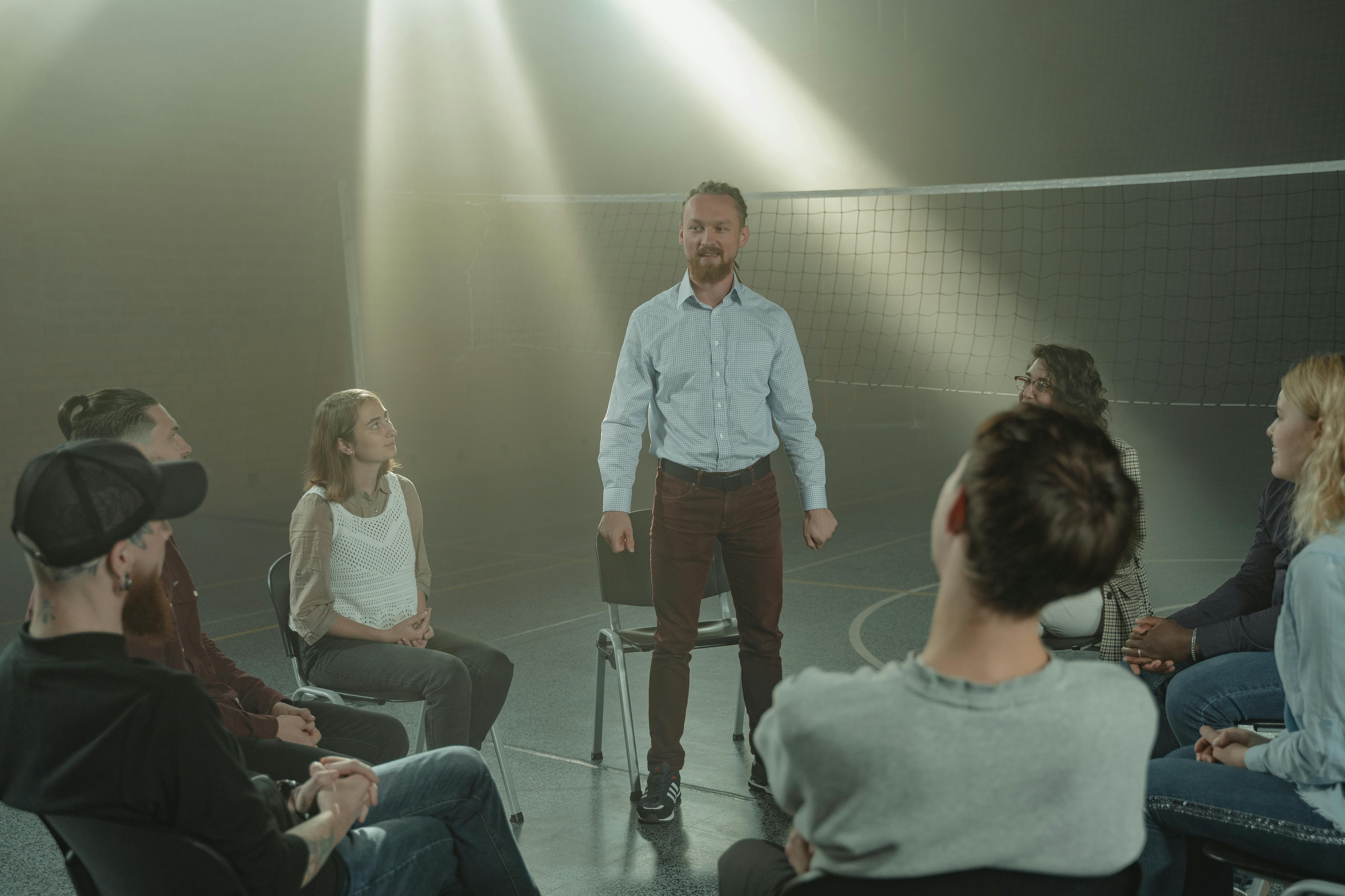 A small group of people sitting together outdoors, engaged in conversation