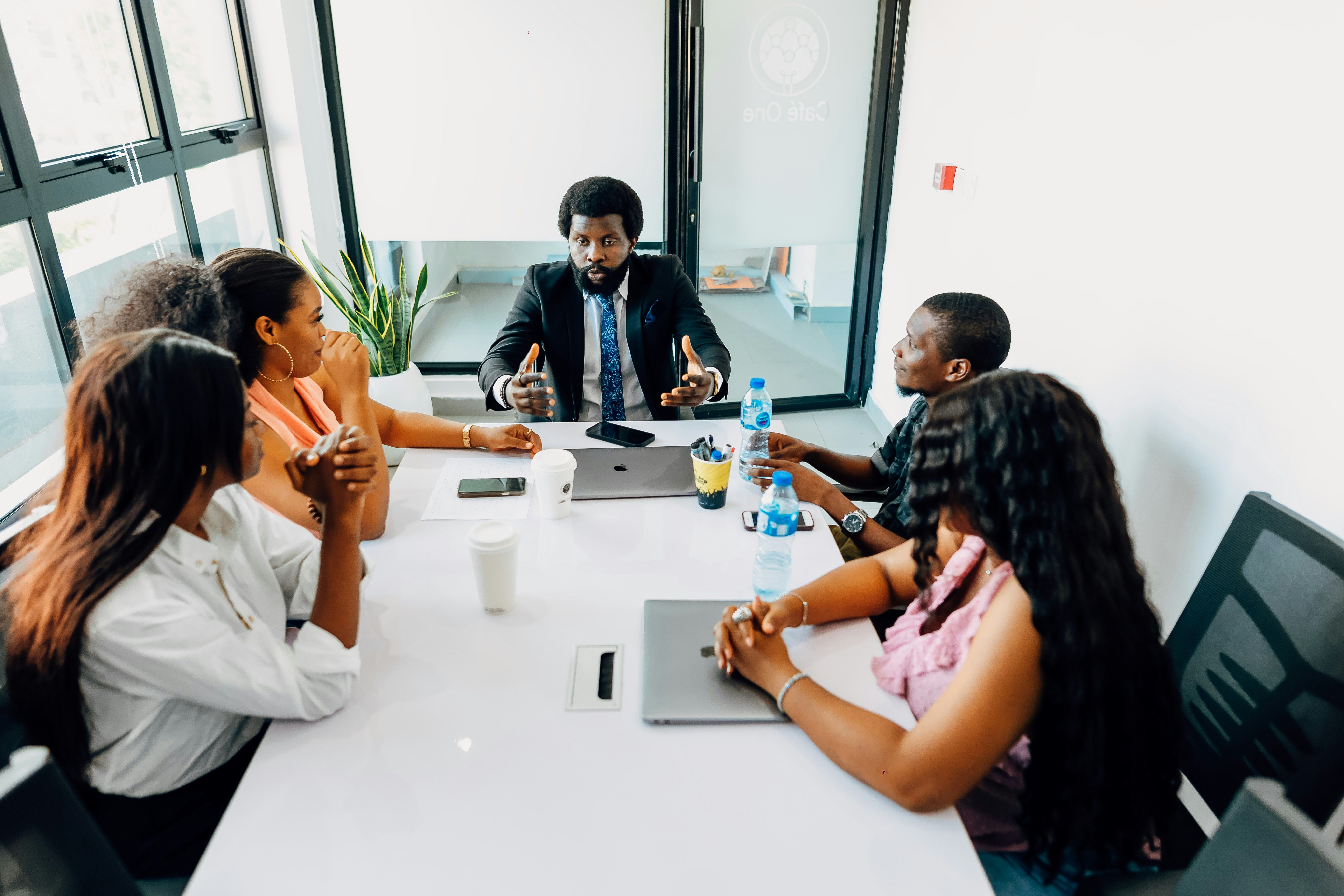 A workplace conversation around a meeting table