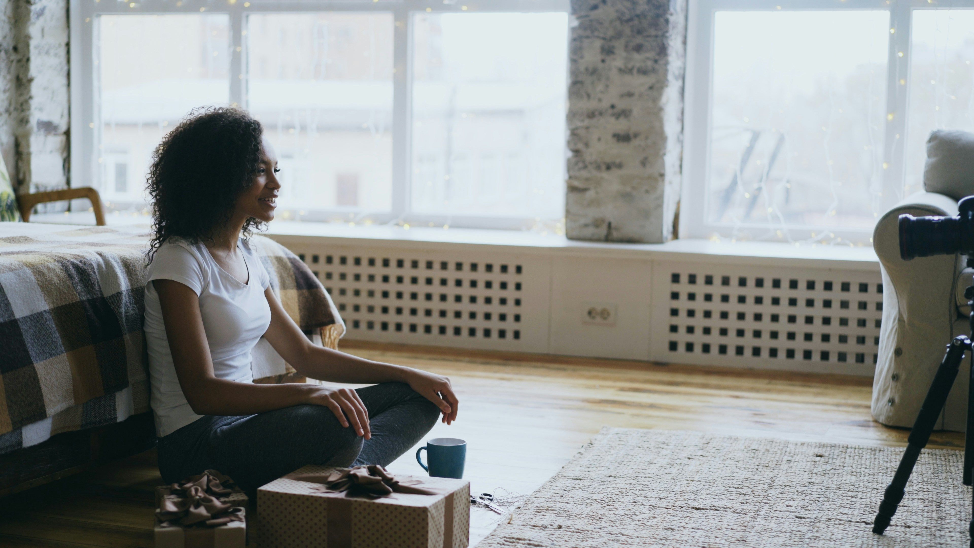 Woman sitting thoughtfully in her room