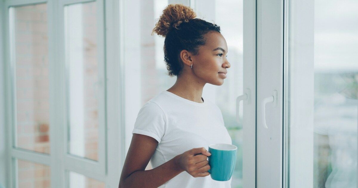 A relaxed person enjoying a cup of tea