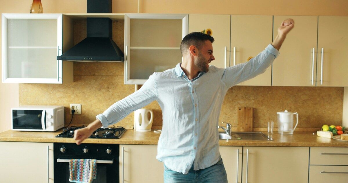 A man dancing freely in his kitchen