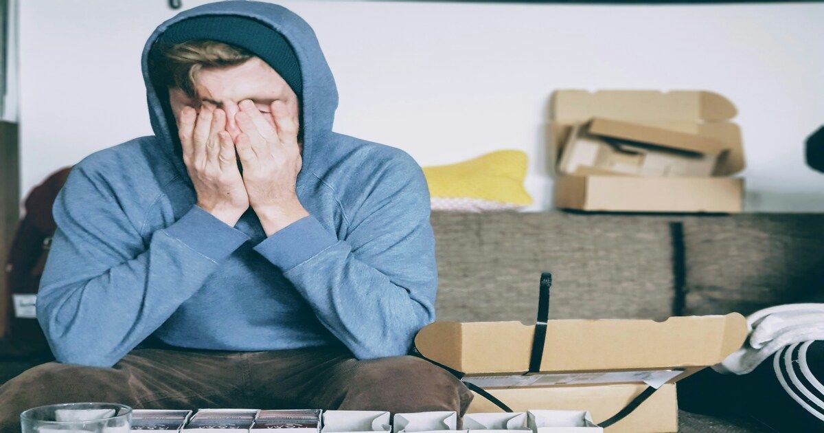 A man with his hand on his face, appearing deep in thought